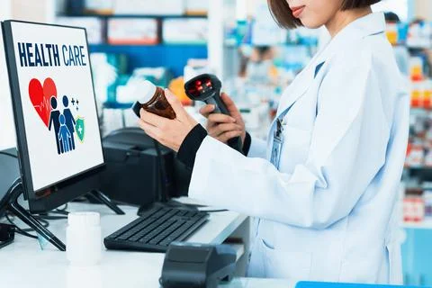 Closeup young pharmacist scanning barcode of mockup qualified pill bottle. Stock-Fotos