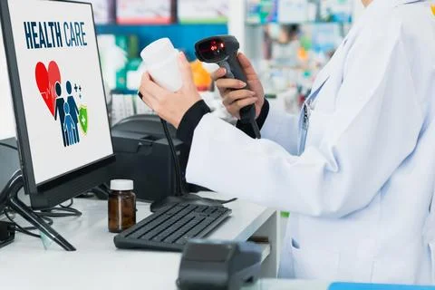 Closeup young pharmacist scanning barcode of mockup qualified pill bottle. Stock-Fotos