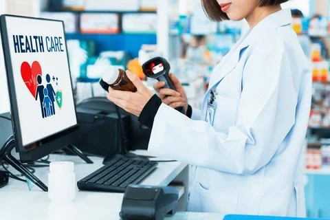Closeup young pharmacist scanning barcode of mockup qualified pill bottle. Stock-Fotos