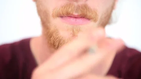 Closeup of young red-haired bearded man smoking a joint Stock Footage 69221872