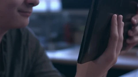 Closeup of young smiling man reading on a tablet Stock Footage 75277852