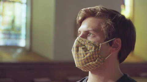 Closeup of young white man wearing mask in church Stock Footage 133096161
