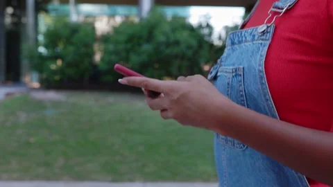 Closeup of young woman hands using mobile phone walking at city street. Stock Footage 286160912