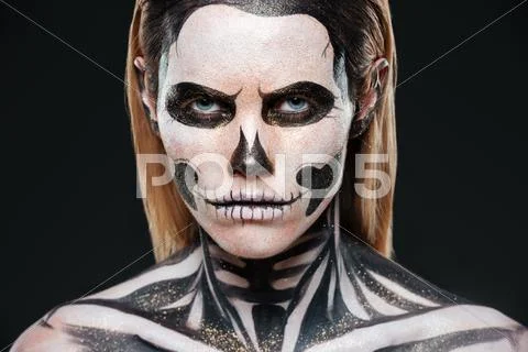Closeup of young woman with terrifying skeleton makeup Stock Photos