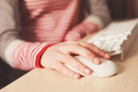 Closeup on young woman using computer mouse Foto stock