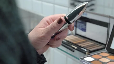 Closeup of a young woman's hands opens an eyelash mascara containter. Stock Footage 127500165