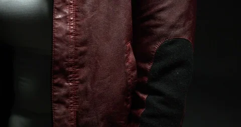 Closeup of young woman's red jacket hidden in shadows Stock-Footage 97520440