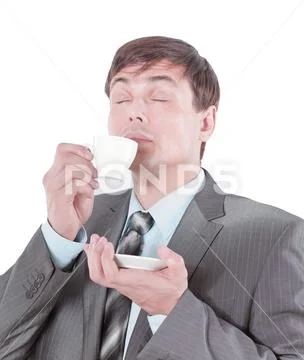 Closeup.handsome businessman inhaling the aroma of fresh coffee. Stock Photos