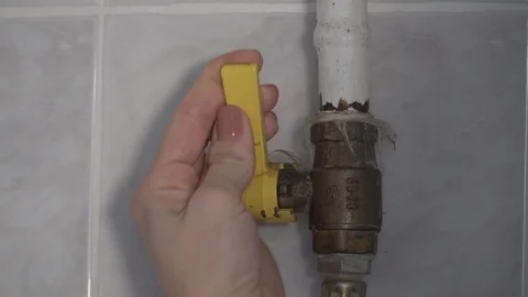 Closing and opening gas pipe with female hand Stock Footage 97708125