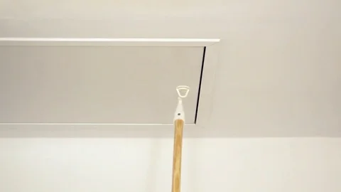 Closing attic ladder door with a stick, Stock Video