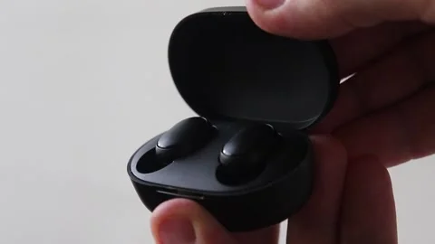 Closing a box with Redmi wireless Bluetooth headphones Stock Footage 141326396