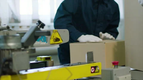 Closing a cardboard box on a conveyor belt line. Stock Footage 237487608