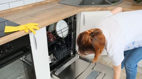 Closing dish washing machine door. Dishware inside built-in dishwasher Stock Footage 108607319