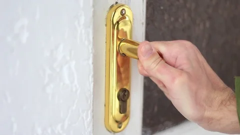 Closing a door with a golden handle Stock Footage 71952891
