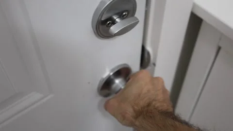 Closing a door lock deadbolt twist knob Stock Footage 310859552