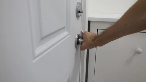 Closing a door lock deadbolt twist knob Stock Footage 310859558