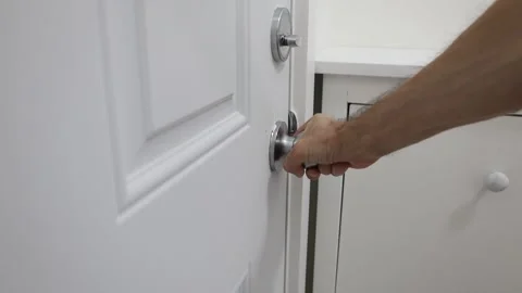 Closing a door lock deadbolt twist knob Stock Footage 310859559