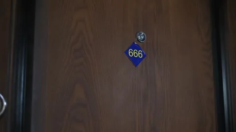 A closing door with the number "666" in a hotel or apartment Stock Footage 336027439