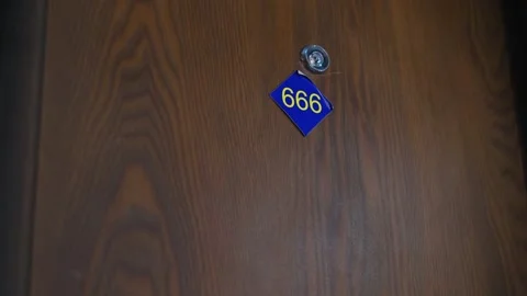A closing door with the number "666" in a hotel or apartment Stock Footage 336027445