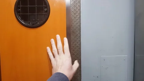 Closing up doors on an old elevator and descending to ground floor Video stock 99511659