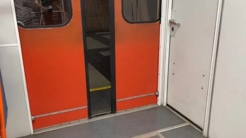 Closing the doors of the train in the subway. orange old vintage doors Stock Footage 247463135