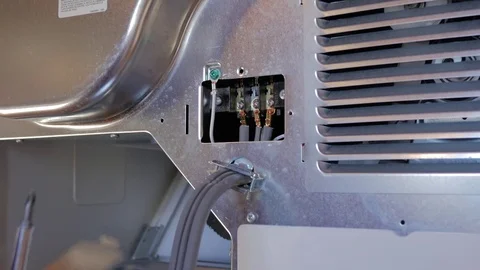 Closing electrical panel on a new appliance. Stock Footage 69868604