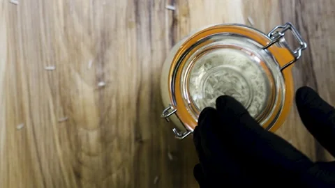 Closing glass jar with toggle clamp on wooden table top view, 4K Stock-Footage 342542725