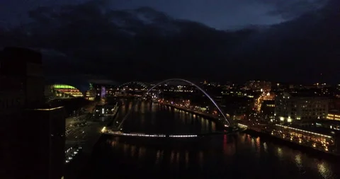 Closing in on illuminated Gateshead Millenium Bridge at night Stock Footage 159145775