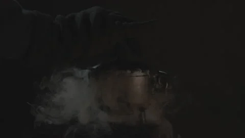 Closing Lid on Boiling Cauldron Spewing Plumes of Smoke in Slow-Mo Stock Footage 138614706