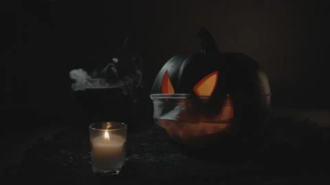 Closing Lid on Smoking Cauldron with Jack-O-Lantern in Face Mask | Halloween Stock Footage 138186093