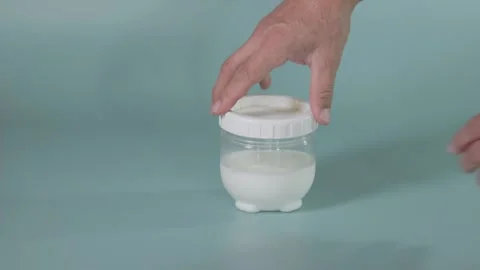 Closing the lid of a yogurt fermentation container Stock-Footage 345881630