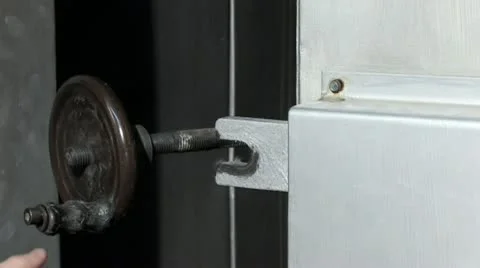 Closing the metalic door Stockbeeldmateriaal 10900922