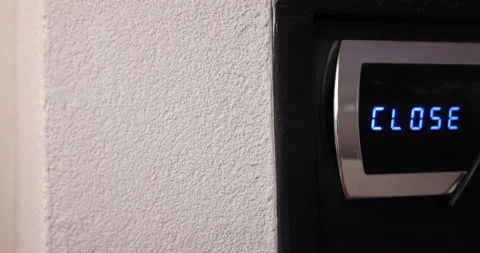 Closing the safe and setting up opening combination by female hand in hotel room Video stock 165118722