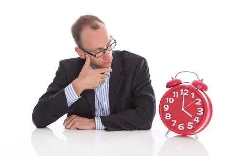 Closing time at four o'clock: isolated businessman looking pensive at a red a Stock Photos