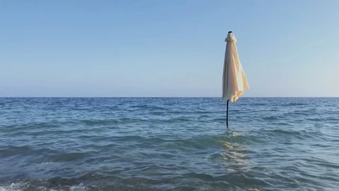 Closing umbrella in the sea Stock Footage 81802201