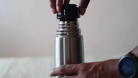 Closing a warm thermos. Hot water container closing Stock Footage 242537885