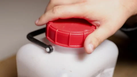 Closing a white plastic container with a lid. Tank for storage of various stocks Stock Footage 175890372