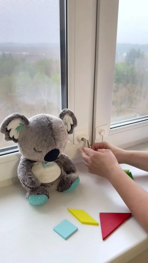 Closing window and locking child safety blocker with key demonstration closeup Stock Footage 321749607