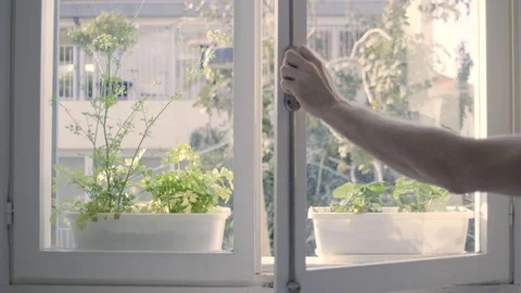 Closing a window. mans hand shutting the a glass window Stock Footage 128438015