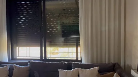 Closing Window Roller Shutters in a Living Room Video stock 345741042