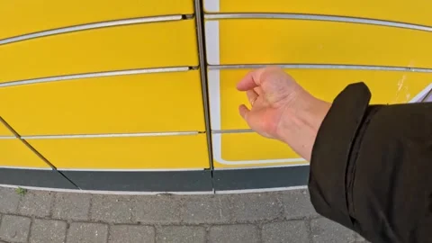 Closing yellow door of parcel sending and recieving machine, POV Stock Footage 309567988