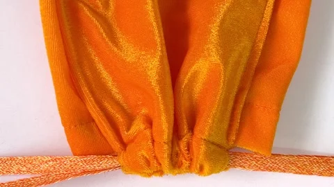 Closing yellow velvet drawstring pouch.Drawstring bag for make merit Stock Footage 311455397