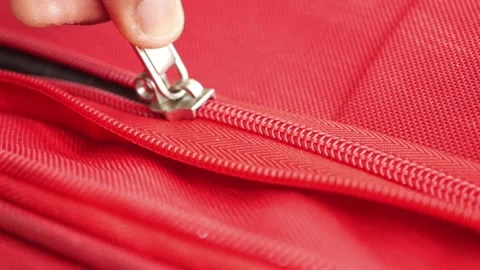 Closing a zipper on a red bag for a quick trip 스톡 동영상 336227226