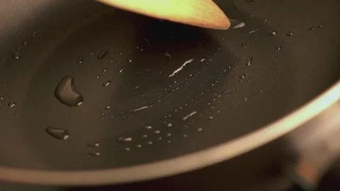 Closs-up Preparing the vegetable oil in the pan for cooking. Stock Footage 196973025