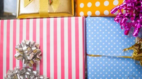Closuep image of high stack of colorful Christmas gift box with ribbons and bows Stock Photos