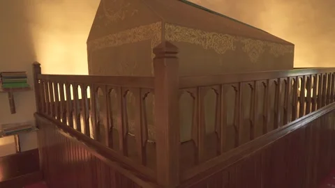 Cloth covered caskets rest inside Islamic tomb, sacred interior reflecting Stock Footage 339815236