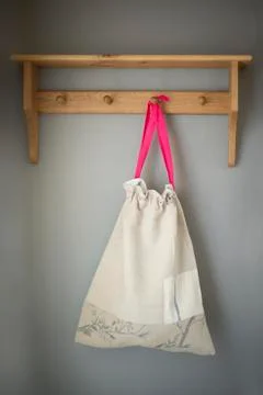 Cloth Drawstring Bag Hanging on Wall Rack Stock Photos