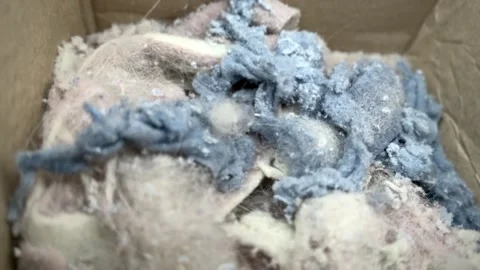 Cloth dust cloud from drying clothes in the dryer,swept together Video stock 302622986