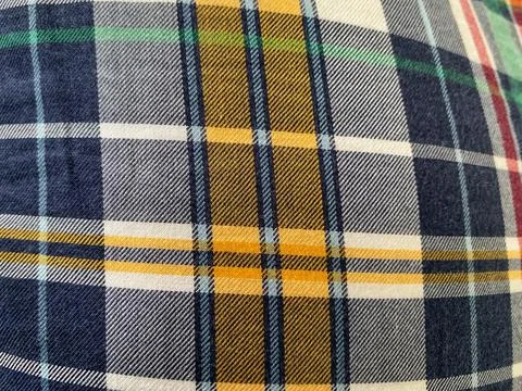 Cloth (fabric) with a square pattern dominated by blue, orange, red and green Stock Photos