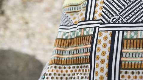 Cloth fluttering in the wind against stone wall Stock Footage 108734059